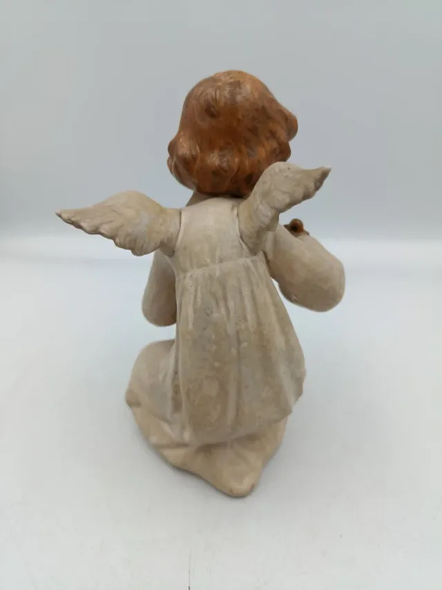 LLADRÓ DE ÁNGEL MIRANDO UN CARACOL