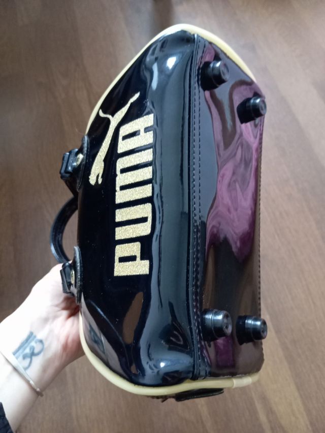 Bolso Puma charol y purpurina negro/dorado
