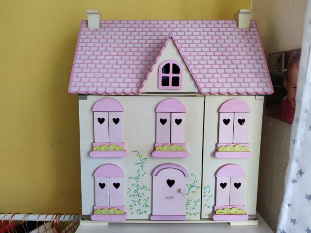 Casa de muñecas rosa y blanca de madera