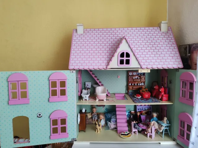 Casa de muñecas rosa y blanca de madera