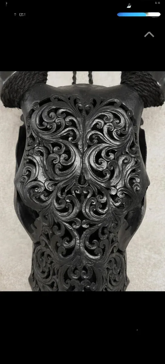 Escultura de calavera negra decorada