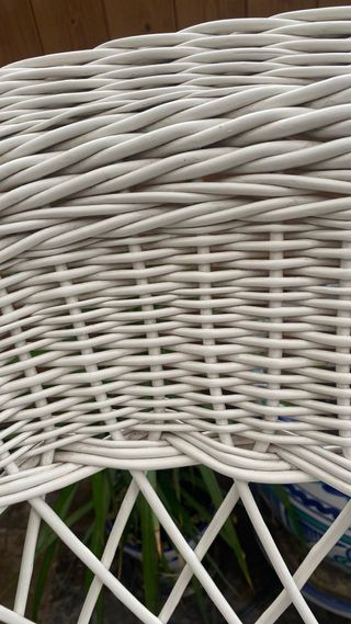 Sillón de mimbre blanco.