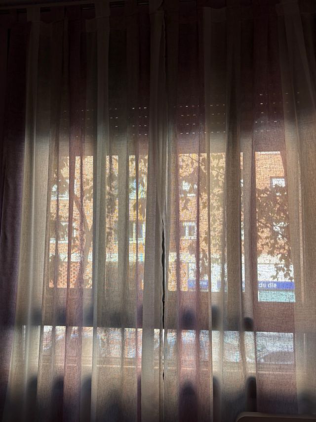 Cortina visillo blanca y lila con barra plateada.