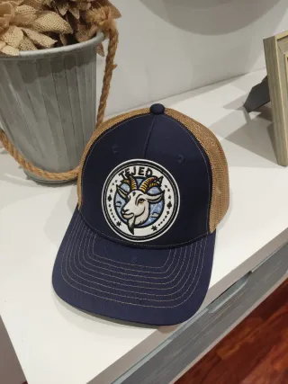 Gorra azul y beige con parche de cabra