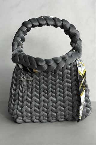 Borsa a mano grigia con foulard e spilla