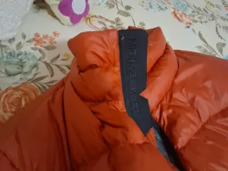 Anorak naranja y negro de plumas