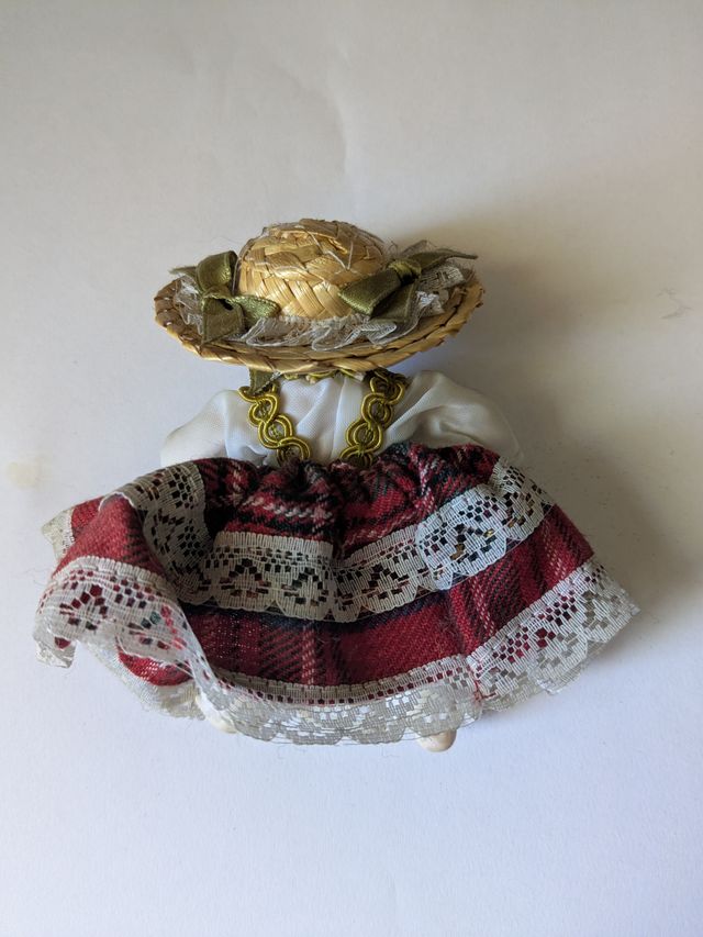Bambola in porcellana con cappello di paglia