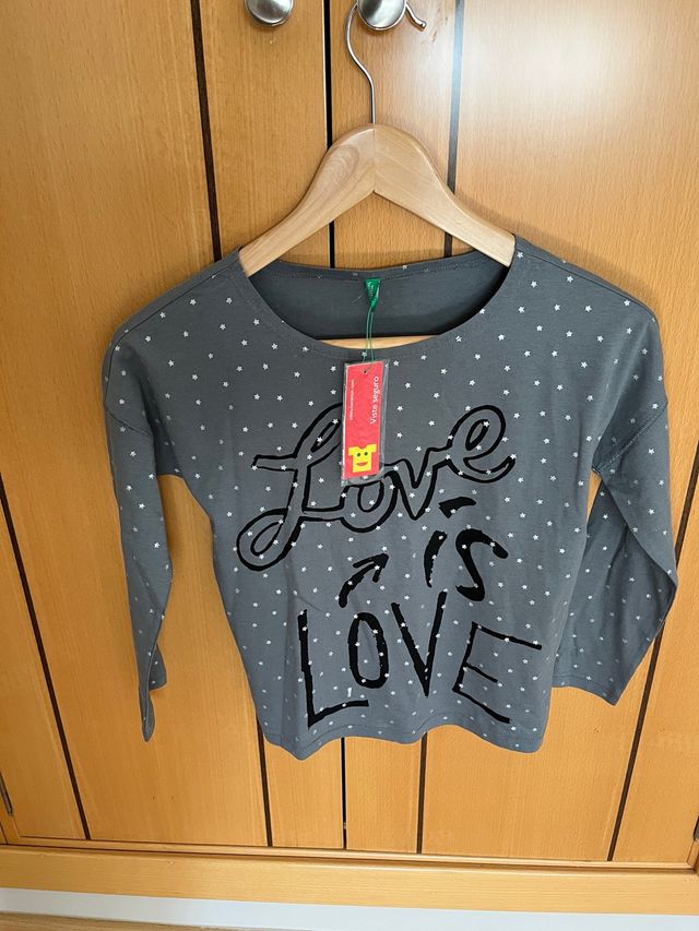 Camiseta gris con estrellas y texto