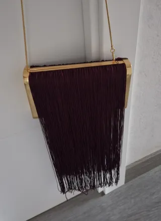 Bolso de mano con flecos y cadena dorada