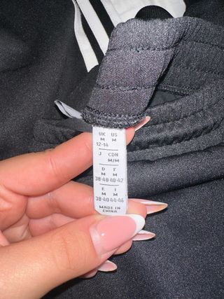 Tuta Adidas nera con strisce bianche