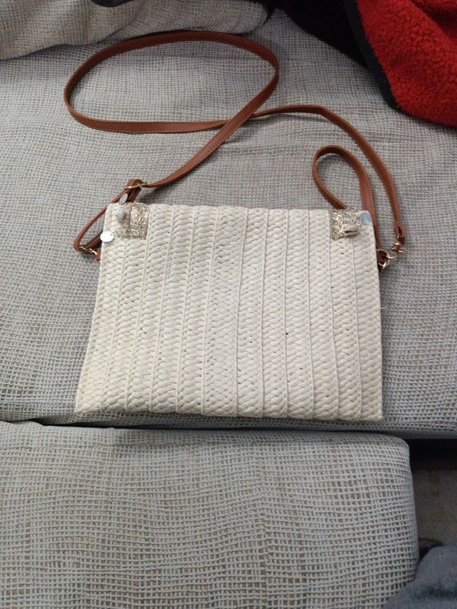 Bolso de playa beige con adornos dorados