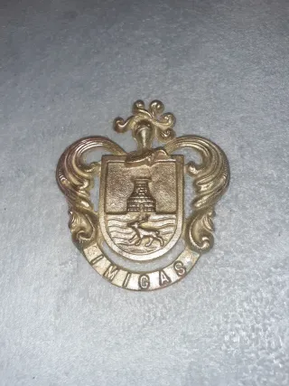 Insignia UMIGAS bronce-laton 13x12 ver