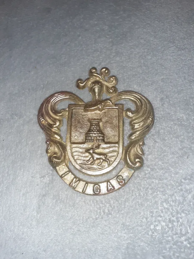 Insignia UMIGAS bronce-laton 13x12 ver