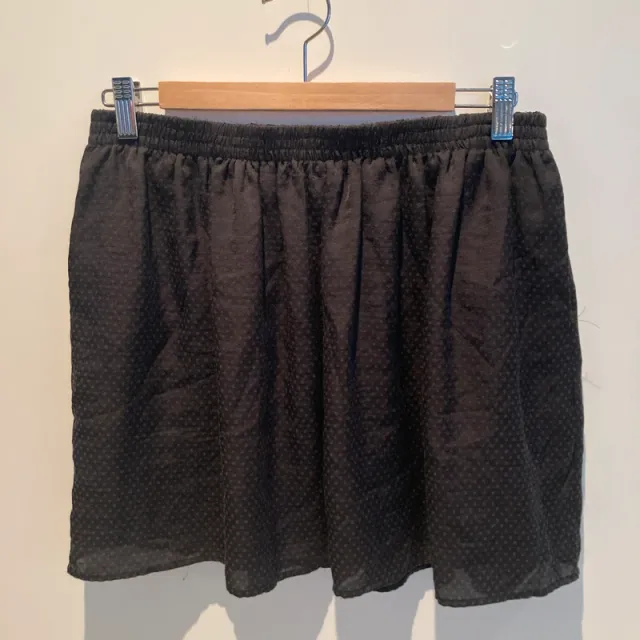 Falda negra ligera con estampado en topos.