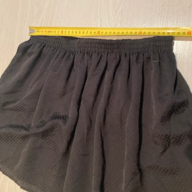 Falda negra ligera con estampado en topos.