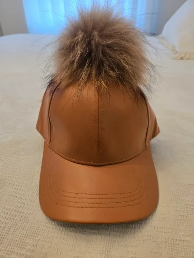 Gorra de cuero con pompón de pelo natural
