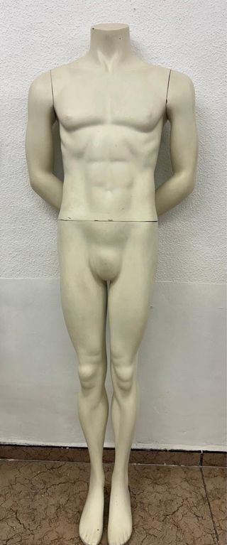 Maniquí de hombre de pie color beige.
