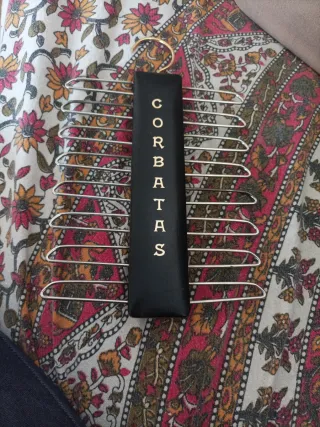 Colgador de corbatas negro con detalles dorados