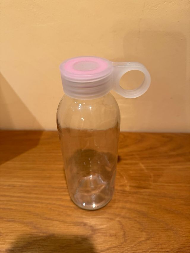 Botella de cristal con tapa rosa