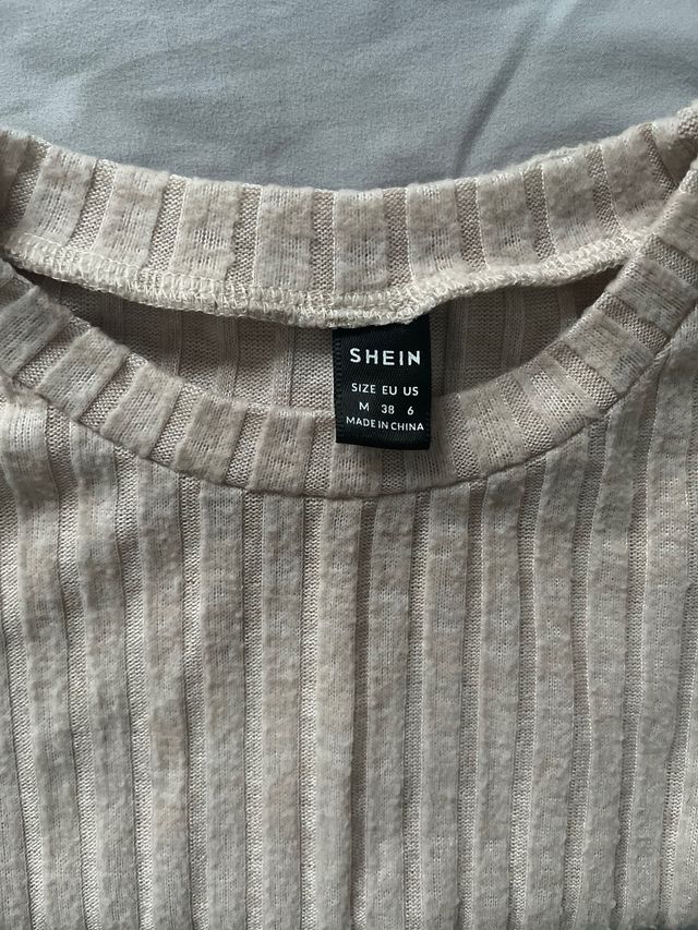 Suéter beige manga larga con nudo