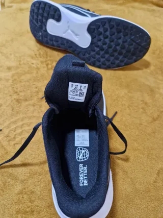 Zapatillas deportivas Puma negras y blancas.