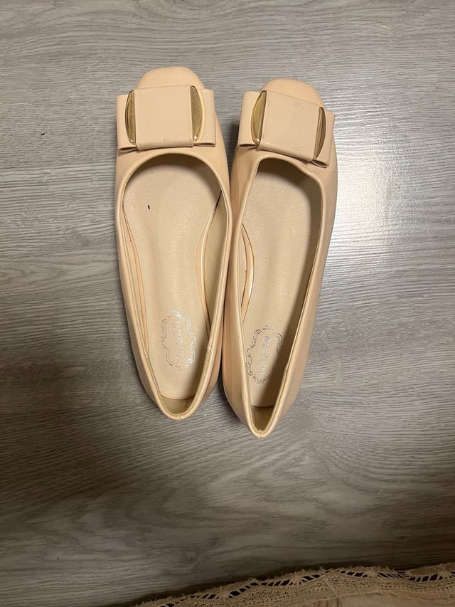 Zapatillas planas beige con lazo dorado