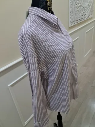 Blusa beige con volantes y cuello alto