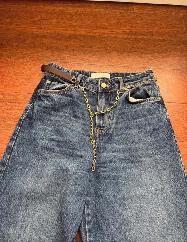 Pantalón vaquero azul con cinturón cadena dorada
