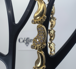 Pulsera pies de bebé dorado con circonitas
