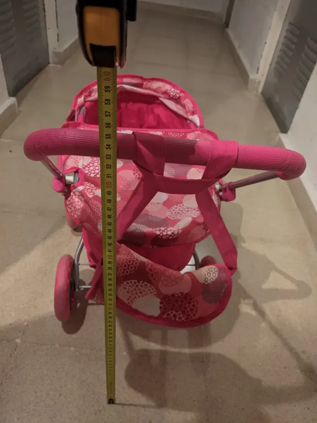 Carrito de bebé de juguete rosa