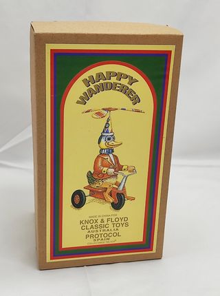 Anatra di latta a molla su triciclo