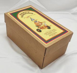 Anatra di latta a molla su triciclo