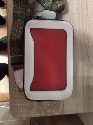 Bolso de mano blanco con tachuelas y cruz