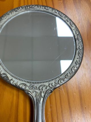 Antiguo espejo de mano plateado con diseño