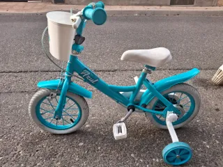 Bicicleta infantil azul con ruedines
