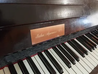 Piano de pared madera oscura.