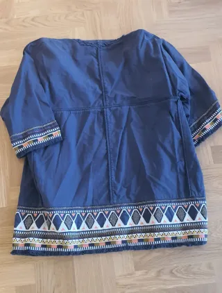 Chaqueta azul marino bordada con abalorios.