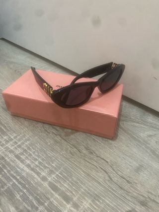 Gafas de sol Miu Miu negras y doradas