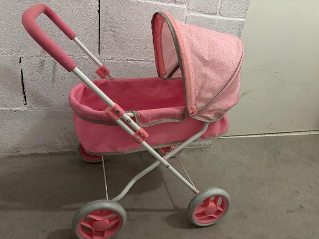 Carro de bebé de juguete rosa