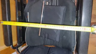 Silla de ruedas alta con cojín.