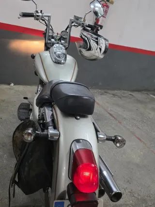 Moto custom plateada con casco