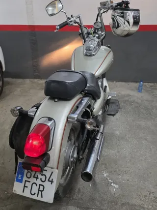 Moto custom plateada con casco