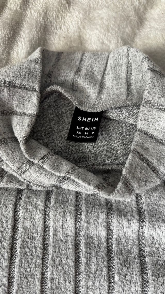 Jersey gris de cuello alto acanalado