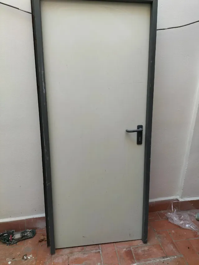Puerta metálica con manilla negra