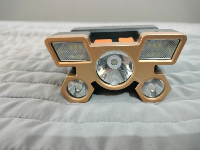 Linterna frontal LED dorada