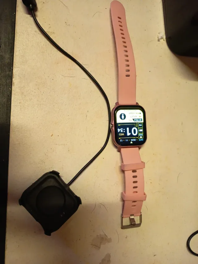 Reloj inteligente rosa con cargador