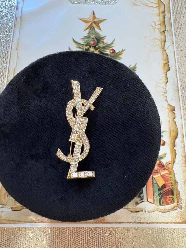 Broche dorato Yves Saint Laurent YSL