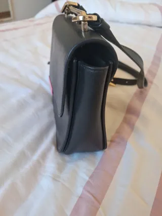 Bolso Furla negro y dorado con detalle rosa