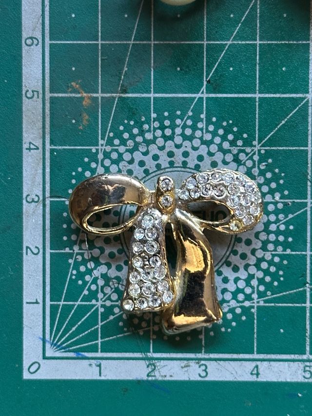 Broche lazo dorado con pedrería