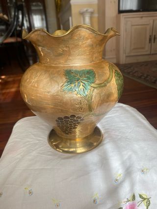 Jarrón de metal dorado con uvas